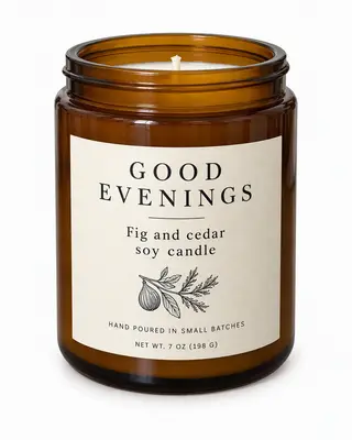 Good Evenings fig and cedar soy candle in an amber jar on a white background