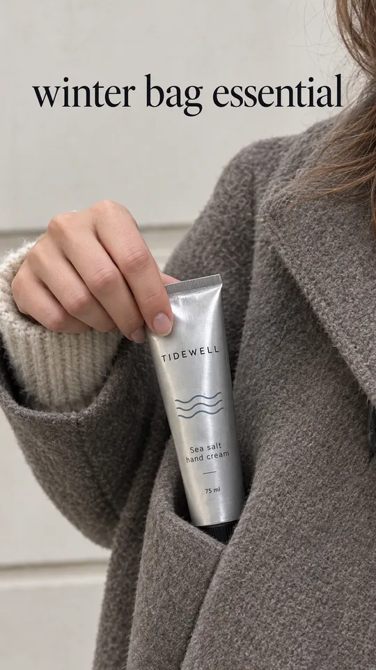 Instagram Story with "winter bag essential" written across it: a woman pulling the Tidewell hand cream tube out of her coat pocket