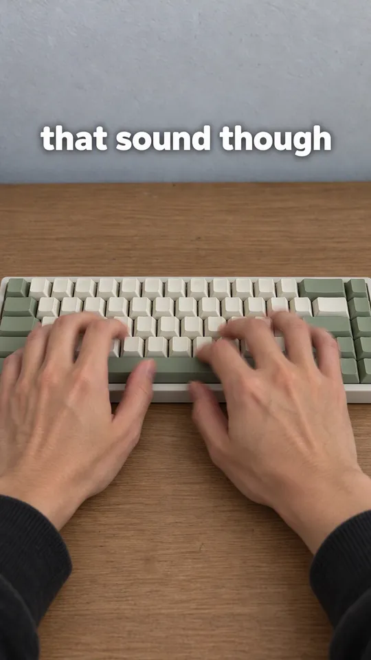 TikTok with the hook "that sound though": fingers typing quickly on the cream and sage keyboard, close crop