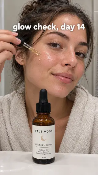 TikTok with the hook "glow check, day 14": a woman pressing a drop of the Pale Moon serum onto her cheek, close and natural